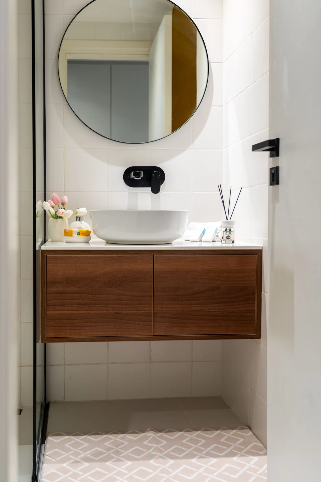 Round mirror above a bathroom basin